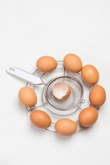 Brown eggs on metal stand. Copy space. Flat lay