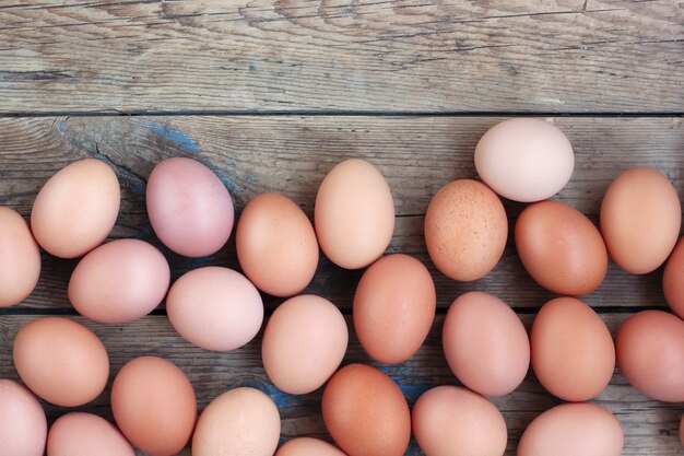 Photo brown eggs on a timber floor, the top view. food, table still life.