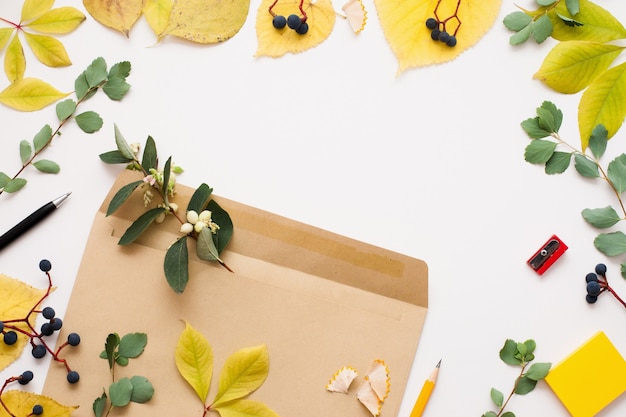 Brown envelope in autumn leaves frame, copy space