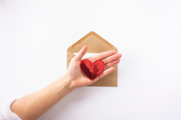 A brown envelope with red hearts in it for ValentineÃ¢ÂÂs Day