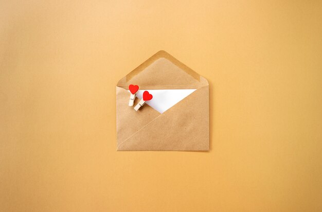 A brown envelope with red hearts in it