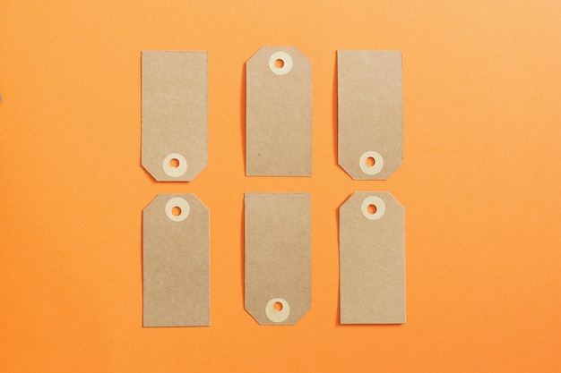 Brown etiquette of kraft cardboard on an orange background Mockup Sale theme