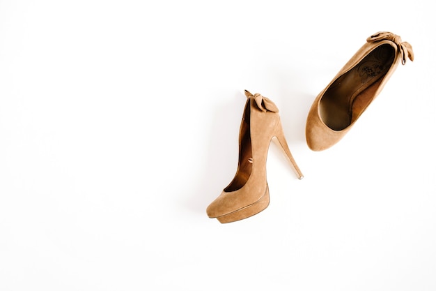 Brown female high heel shoes isolated on white background. Flat lay