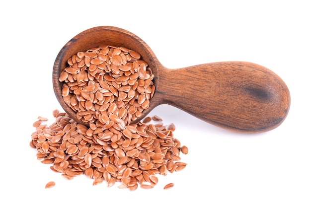 Brown flax seeds in wooden spoon isolated on white background heap of dry flaxseed or linseed