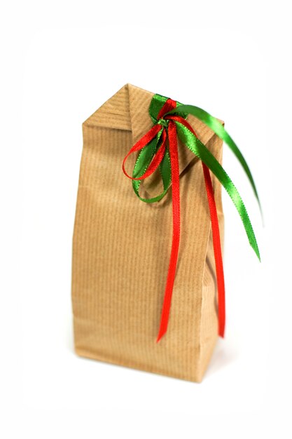 Brown gift bag with ribbons isolated on white background