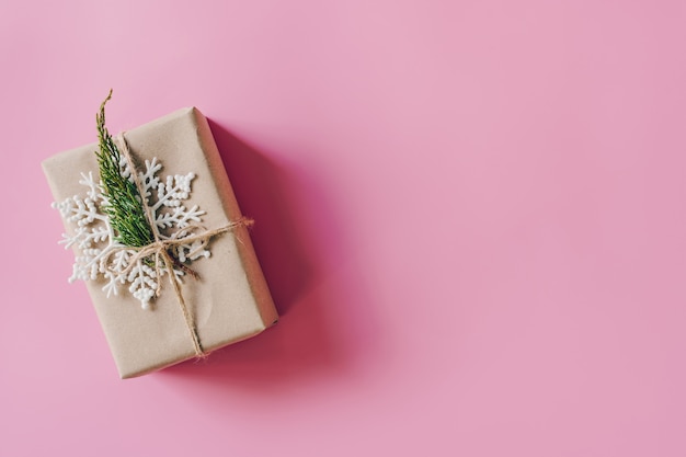 Brown gift box on the pink background. Minimal style holiday card 