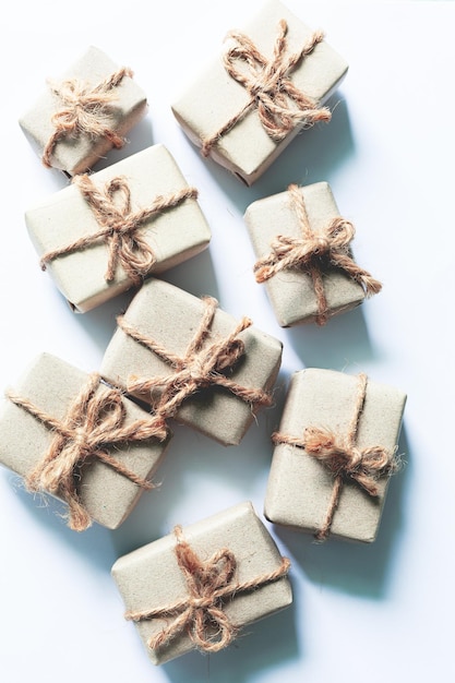 Brown gift box on a white background,A set of handmade gifts in kraft paper, tied with wide twine,