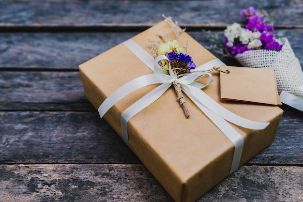 brown gift box white ribbon and vintage flowers 