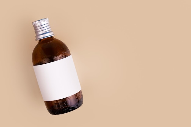 Brown glass bottle on beige background Mock up flatlay Concept beauty and medicinex9