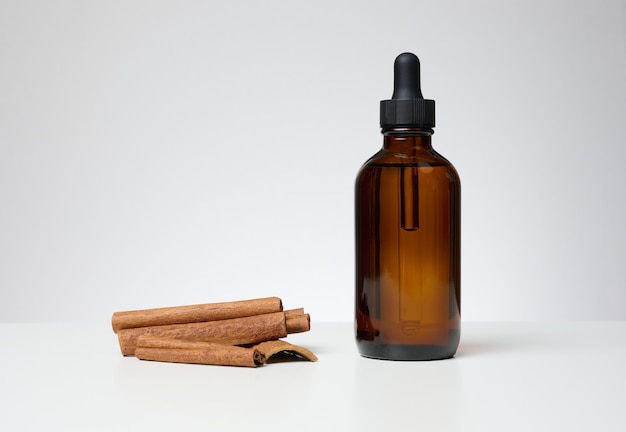 Brown glass bottle with a pipette on a blue background Containers for cosmetics