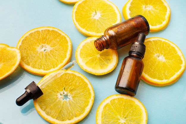 Brown glass bottle with a pipette and orange slices