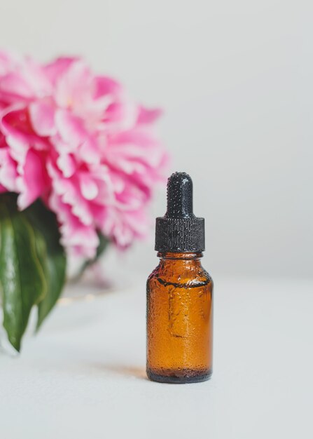 a brown glass bottle with a serum essential oil or other cosmetic product