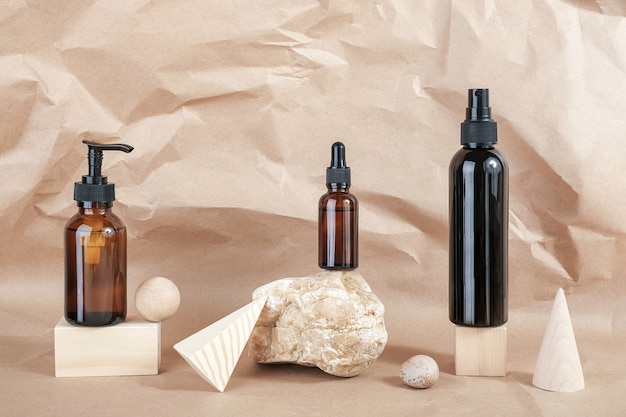 Brown glass bottles of cosmetic products on stone