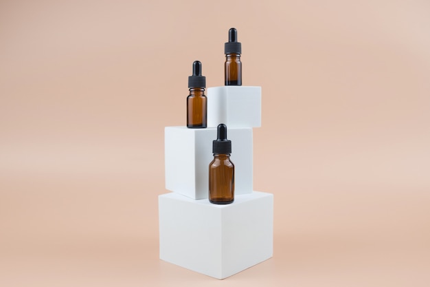 Brown glass bottles with serum, essential oil or other cosmetic product.