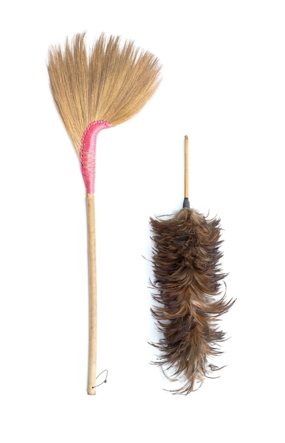 Brown grass broom and feather duster isolated on white background