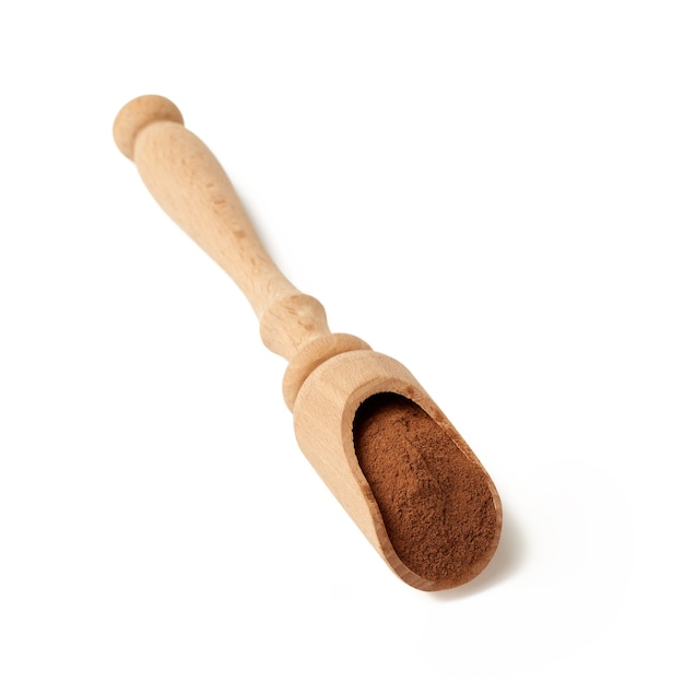 Brown ground cinnamon in a wooden spoon