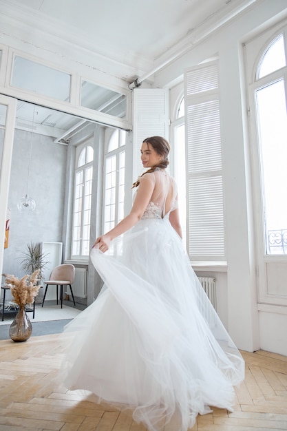 Brown-haired girl in a beautiful white wedding dress.