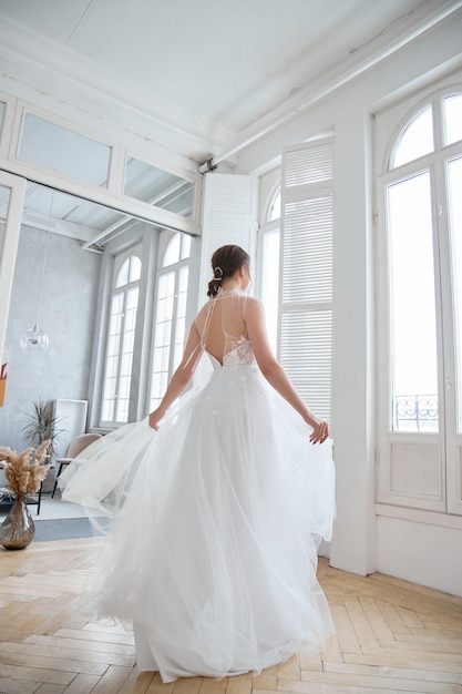 Brown-haired girl in a beautiful white wedding dress.
