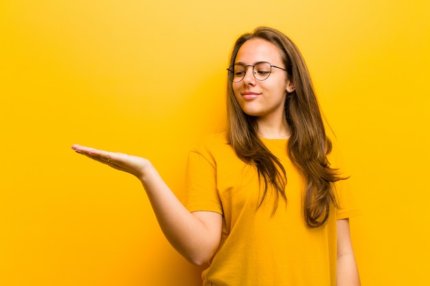 brown haired girl looking to an object held on the hand on the side