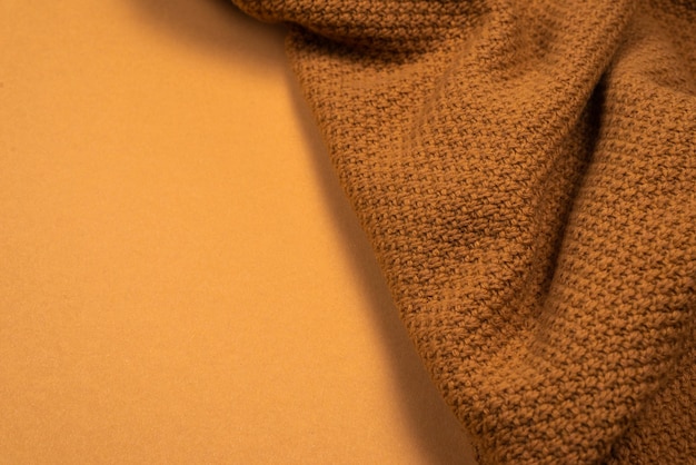 Brown knitted fabric pattern. Warm clothes.
