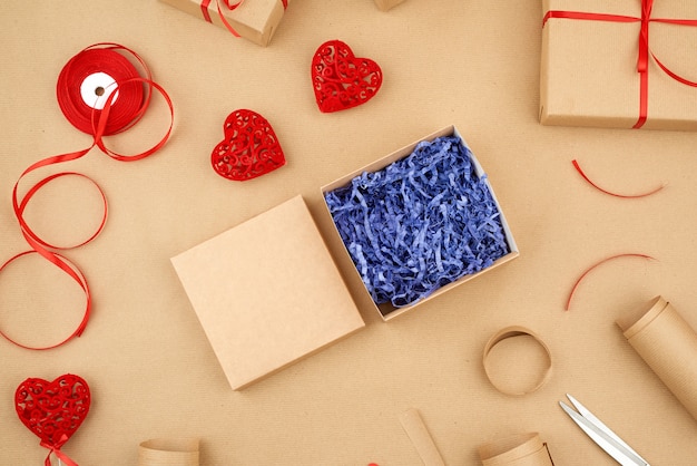 Brown kraft paper, packed gift boxes and tied with a red ribbon