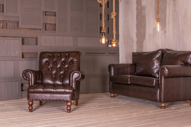 Brown leather armchair and vintage leather sofa interior compositionretro furniture Creative design Copy space