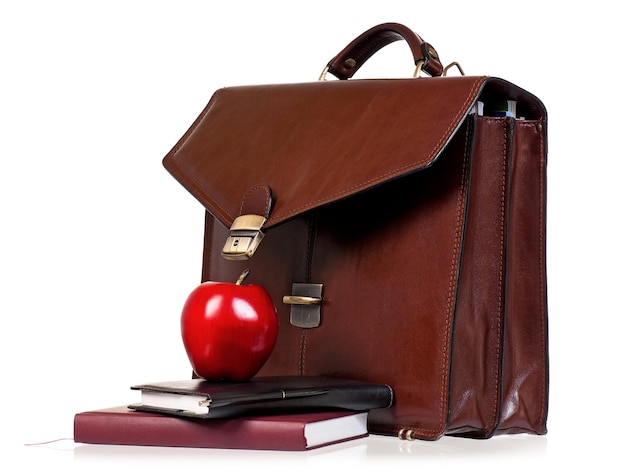 Brown leather briefcase with office accessories isolated on white background