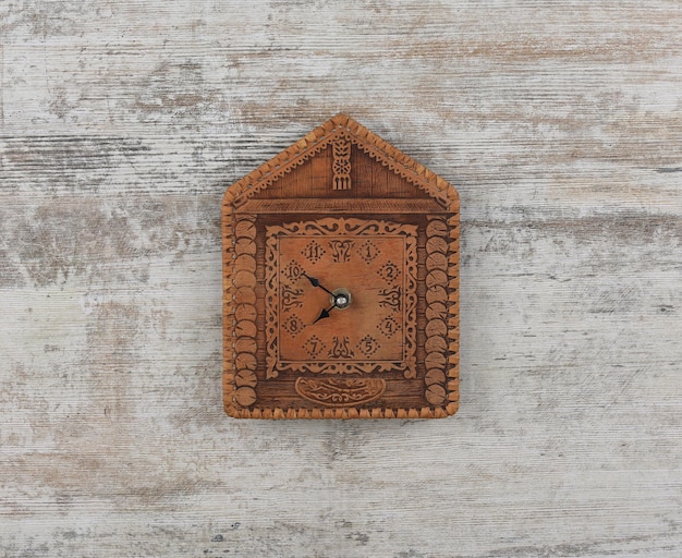 A brown leather clock with the number 12 on it.