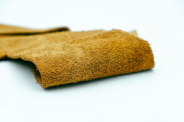 Brown leather is folded on a white background