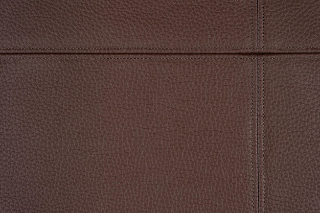 Коричневый кожаный кожзаменитель текстуры фона с декоративной строчкой