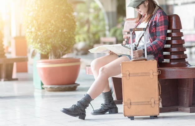 brown leather travel bags with traveler on railway