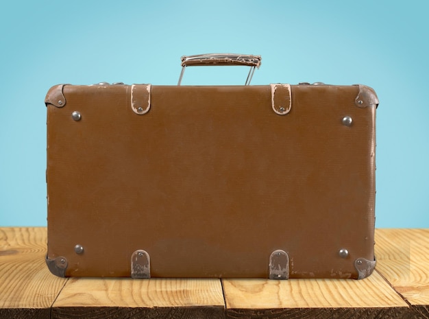 Brown leather vintage suitcase on background