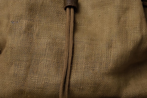 A brown leather zipper is on the front of the bag.