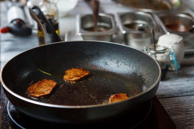 Brown meat on frying pan.