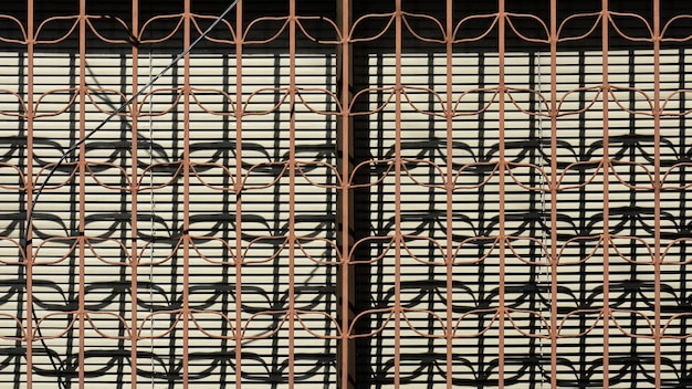 Brown metal fence and the shadow