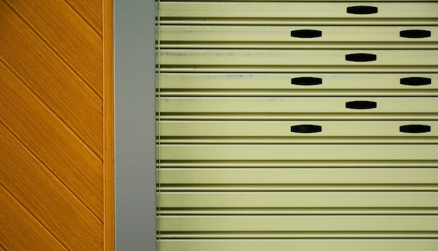 Brown metal slide door at modern wood building