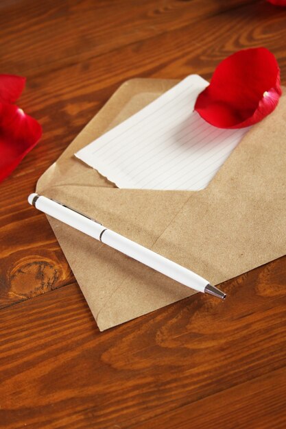 Brown notebook with white pen on a wooden table background Valentine's day february 14