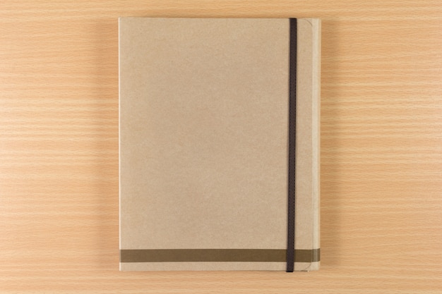 brown notebook on wooden background