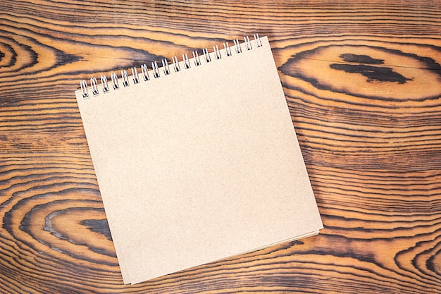 brown notepad on a wooden table View from above