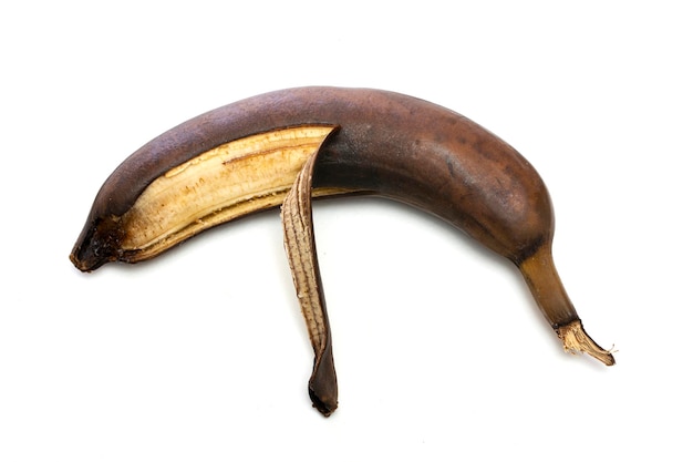 Brown overripe banana on a white background