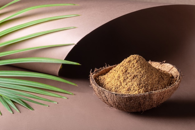 Brown palm sugar in a coconut shell