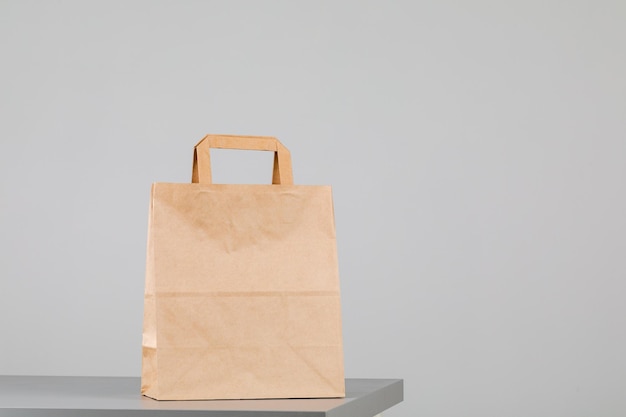 Brown paper bag with handles empty shopping bag with area for your logo or design food delivery concept