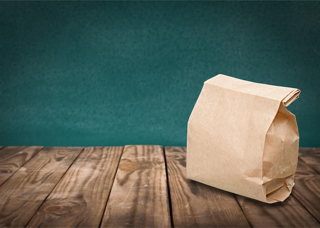 Brown paper bag on wooden desk