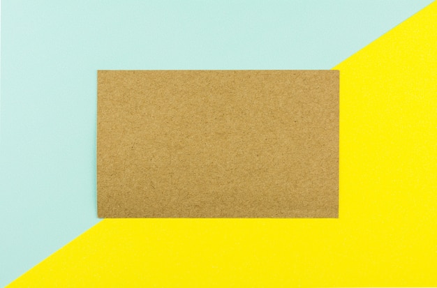 Brown paper on blue and yellow paper background.