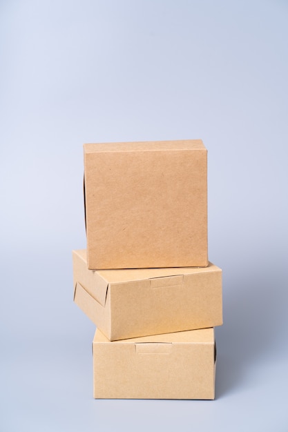 Коробка из коричневой бумаги для упаковки продуктов. коробка на сером.