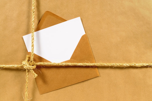 Brown paper parcel with envelope