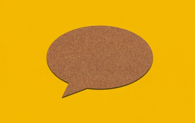 Brown paper speech bubble on yellow paper background