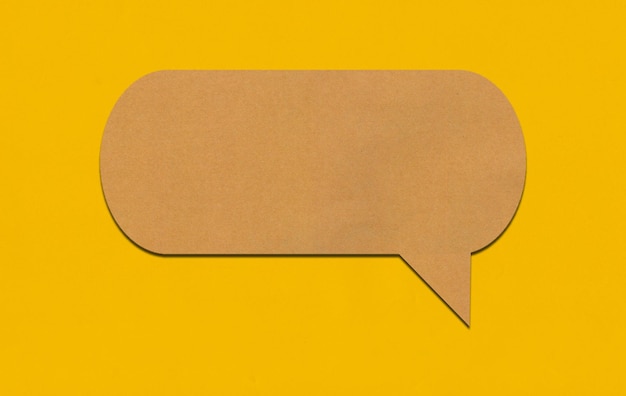 Brown paper speech bubble on yellow paper background