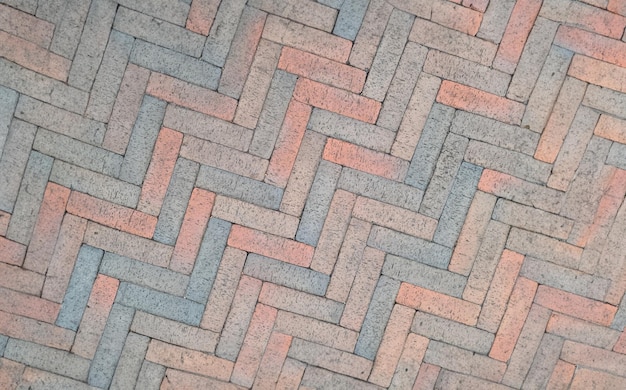 Brown paving slabs laid out in herringbone shape background