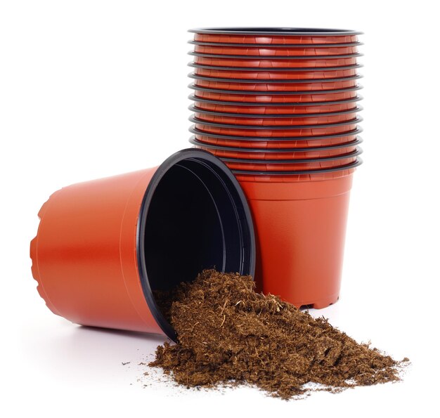 Brown plastic plant pots and soil isolated